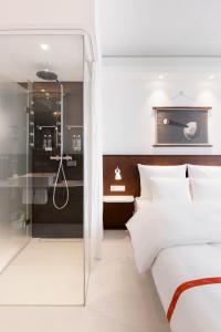 デュッセルドルフにあるRuby Luna Hotel Dusseldorfのベッドルーム(白いベッド1台、シャワー付) +37枚の写真