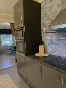 a kitchen with stainless steel appliances and a counter top at Haere Mai B&B Orust in Henån