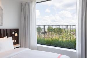 Voodi või voodid majutusasutuse Ruby Zoe Hotel London toas