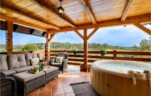 a hot tub on a patio with a wooden ceiling at Beautiful Home In Pisarovina With Wi-Fi in Lipnica