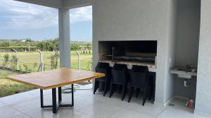 a kitchen with a wooden table and black chairs at Casa Borges in Paraná