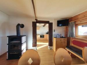 a living room with a wood stove and a couch at Zillertaler Sennhuette in Hart im Zillertal