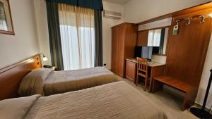 Postel nebo postele na pokoji v ubytování GH Hotel