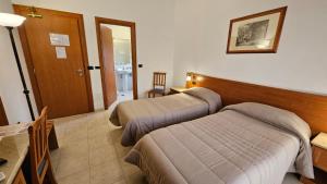 Postel nebo postele na pokoji v ubytování GH Hotel