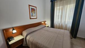 Postel nebo postele na pokoji v ubytování GH Hotel
