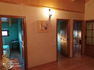 a living room with two doors and a room with at Casa Lucila ,casa rural tres estrellas in Caleruega