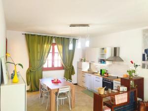 a kitchen with a table and a dining room at CASA MARY in Menfi