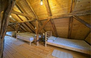 a room with three beds in a wooden attic at Lovely Home In Dragovanscak in Slavetić