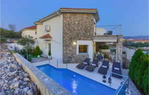 a villa with a swimming pool and a house at Beautiful Home In Krk in Krk +52 photos