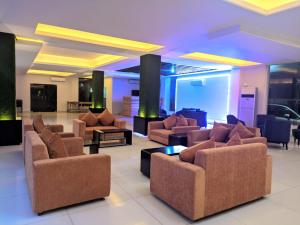 a living room with couches and chairs in a lobby at Hotel Inani Long Bay in Cox's Bazar