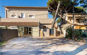 a house with a palm tree in front of it at Awesome Apartment In Hyères With Wifi in Hyères