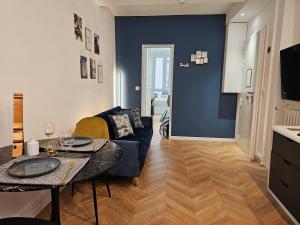 a living room with a couch and a table at Charme apt a Paris ideal for 3p in Paris