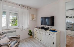 a living room with a tv on a dresser at Lovely Apartment In Rijeka With Wifi in Rijeka