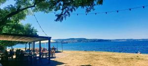 a picnic shelter on the shore of a lake at Magnolia Garden, 12 min walk to the beach in Ankaran