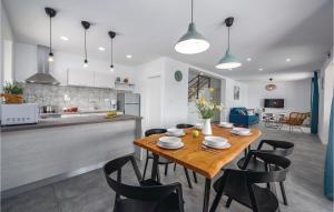 a kitchen and dining room with a wooden table and chairs at Awesome Home In Labin With Wifi in Labin