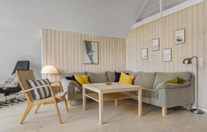 a living room with a couch and a table at Lyngbo in Havrvig
