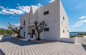 a white house with trees in front of it at Villa Michelle in Maslenica