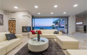 a living room with couches and a vase of flowers on a table at Villa Michelle in Maslenica +45 photos