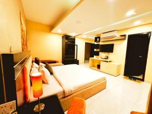 a bedroom with a bed and a living room at Hotel Inani Long Bay in Cox's Bazar