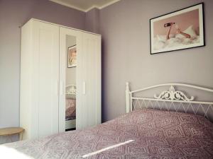 a bedroom with a bed and a mirror at Różowe sny in Kłodzko +2 photos