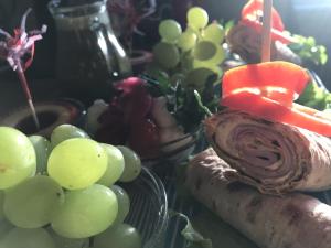 a table topped with grapes and a cake with a candle at Haere Mai B&B Orust in Henån +32 photos