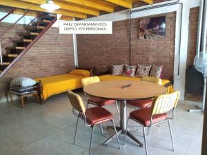 a room with a table and chairs and a couch at Departamentos PAEZ in Malargüe