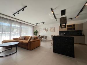 a large living room with a couch and a table at Blanch Holiday Apartments in St Paul's Bay