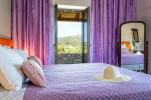 a bedroom with a bed with a hat on it at Villa Kamaraki in Patellárion +28 photos