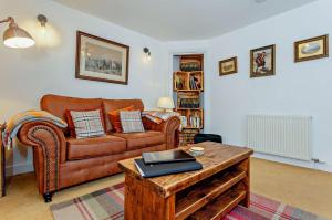 a living room with a couch and a coffee table at Jacobite's Retreat, 17th century cottage in the heart of Inverness in Inverness