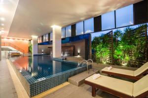 a large house with a swimming pool and a house at Beyond Suite in Bangkok