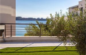 a balcony with a view of the water at 2 Bedroom Stunning Apartment In Omisalj in Omišalj +15 photos