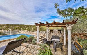 a gazebo with chairs and a swimming pool at Two-Bedroom Holiday Home In Drvenik Veli in Veliki Drvenik