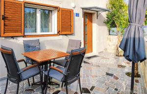 a table and chairs and an umbrella on a patio at Gorgeous Home In Kmeti With Wi-Fi in Kmeti