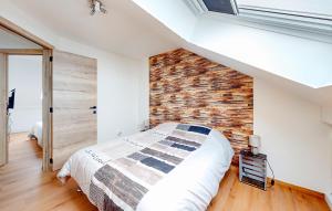 a bedroom with a brick wall and a bed at 3 Bedroom Beautiful Home In Charnois in Charnois