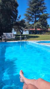 a person in a swimming pool with their feet in the water at La Celeste in La Granja +18 photos