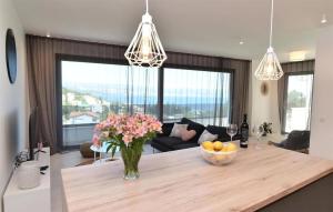 a kitchen with a table with a vase of flowers at 2 Bedroom Nice Home In Icici in Ičići