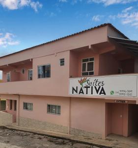 a building with a sign that reads suites nationalva at Suítes Nativa STL in São Thomé das Letras