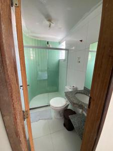 a bathroom with a toilet and a shower and a sink at Pousada Estrela Mares 307 in Cabo Frio