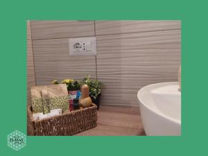 a bathroom with a sink and a toilet and a tub at Elmas Room in Elmas +16 photos