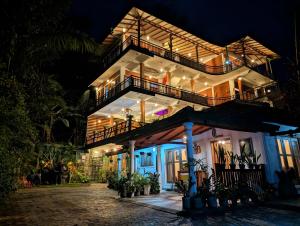 a large building with a balcony at night at Rawana Mount View - Ella in Bandarawela