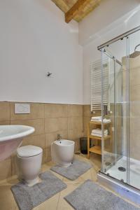 a bathroom with a toilet and a sink and a shower at kis inn affitacamere guesthouse in Rome +50 photos