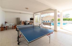 un tavolo da ping pong nel mezzo di un soggiorno di Five-Bedroom Holiday Home In Prizba a Prižba