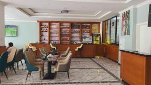 a restaurant with a table and chairs and a bar at Nahusenay hotel in Addis Ababa