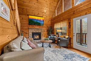 a living room with a couch and a fireplace at NewListing 1mile Parkway, GameRoom, HotTub, BBQ, Sleeps 14, 5 Bedroom with attached Bath, PET Friendly in Pigeon Forge