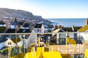 a balcony with a table and a view of the ocean at Bright & beautiful 4 bedroom house with sea views in Portland