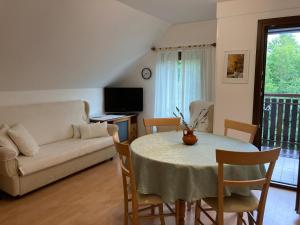 a living room with a table and a couch at Apartment Makuc in Bovec