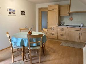 a kitchen with a table with a blue table cloth at Apartment Makuc in Bovec