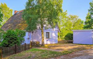 a purple house with a fence and a tree at Amazing Home In Prerow With Wifi in Prerow