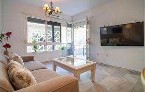 a living room with a couch and a coffee table at Cozy Apartment In Fuengirola With Wifi in Fuengirola