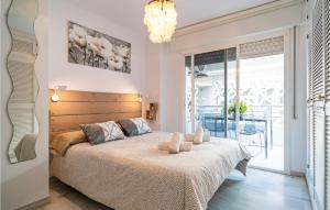 a bedroom with a bed and a large window at Cozy Apartment In Fuengirola With Wifi in Fuengirola +10 photos
